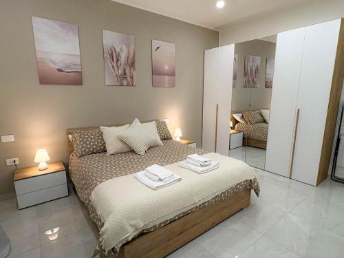 a bedroom with a bed with two towels on it at Nicola's Apartments in Santa Maria La Carità