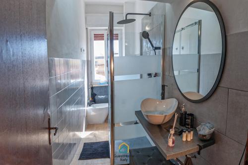 a bathroom with a sink and a mirror at Argent House Orbetello in Orbetello