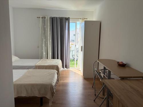 a hotel room with two beds and a balcony at La Playa in Adeje