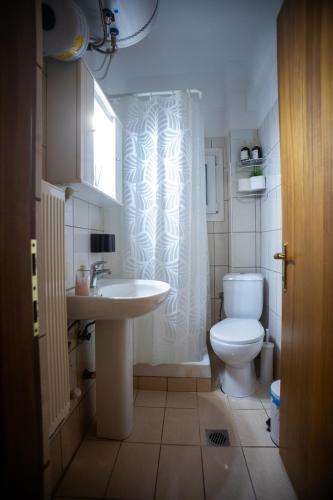 a bathroom with a toilet and a sink at The 5th floor in Florina
