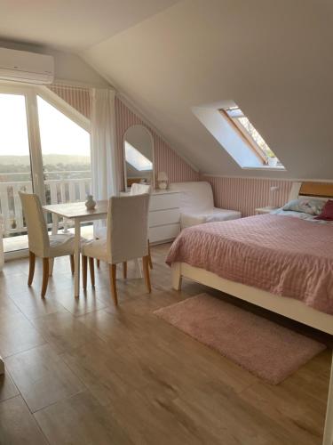 a bedroom with a bed and a table and chairs at Noclegi Bajama in Siepraw