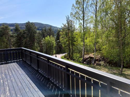 a viewing deck with a view of the woods at The Sisters Landeskogen in Grendi