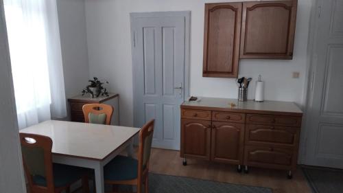 a kitchen with a table and a wooden cabinet at Löwenzahn in Scheibbs