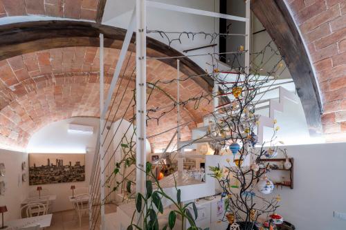 a spiral staircase in a room with a brick wall at Il Nido Di Anna in San Gimignano