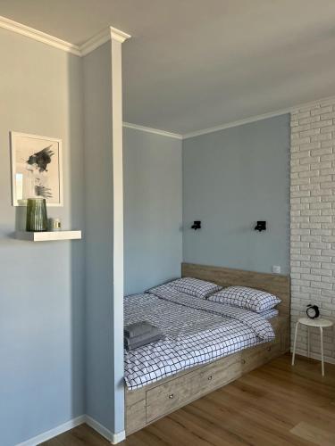 a bedroom with a bed in a white room at Sisters apartment Val in Chernihiv