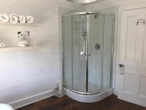 a shower with a glass enclosure in a bathroom at The Old Salt Box Co. - Evelyn's Place in Herring Neck