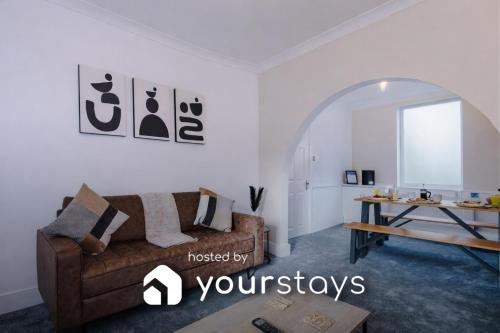 a living room with a couch and a table at Oxford House by YourStays - Cosy Home in the Suburb of May Bank in Stoke on Trent