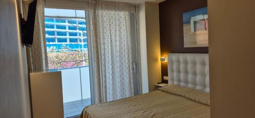 a bedroom with a bed and a large window at Avenida Diagonal - Próximo a Sagrada Familia y parking gratis - Angeles Terraza in Barcelona