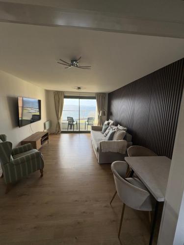 a living room with couches and a view of the ocean at View of the Isles 2 in Largs