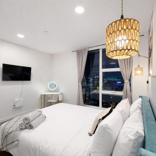 a bedroom with a bed and a window with a chandelier at Cozy Spokane Apt in Spokane