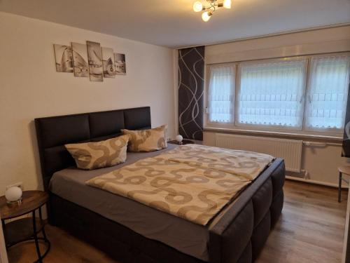 a bedroom with a large bed in a room at Ferienwohnung Lux in Markische Heide