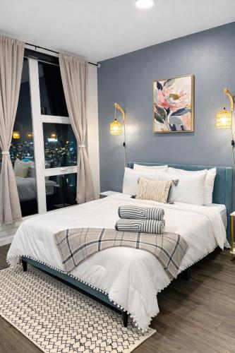 a bedroom with a large white bed and a window at Cozy Spokane Apt in Spokane