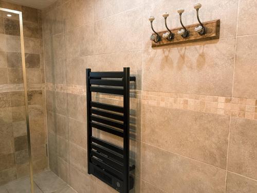 a shower with a black towel rack in a bathroom at Les Crins Du Bonheur Chambre et Table Hôtes Belle Vue in Fraisse