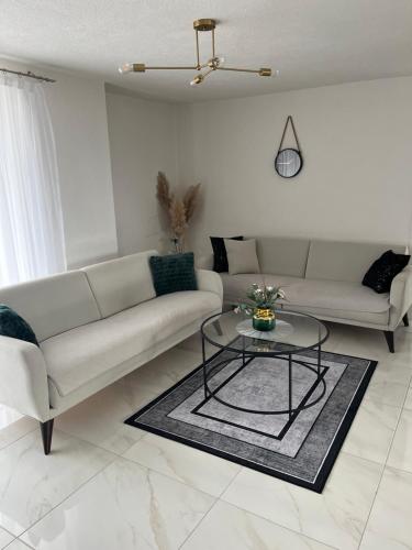 a living room with a couch and a table at Apartman Stari Grad in Cazin
