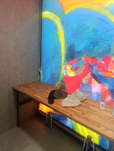 a wooden bench in front of a painting at Azat - Toon in Garni