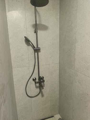 a shower with a shower head in a shower stall at Azat - Toon in Garni