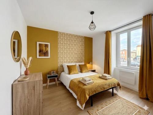 a bedroom with a bed and a large window at 8C - L'Urban in Saint-Rambert-dʼAlbon