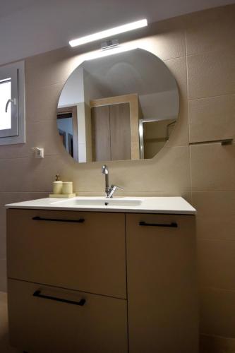 a bathroom with a sink and a mirror at Thea Hill in Kritharia
