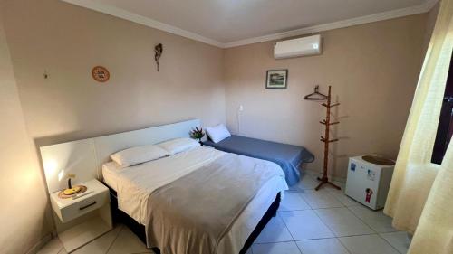 a bedroom with a bed with a blue bedspread and a bed sidx sidx sidx at Casanostra44 in Genipabu