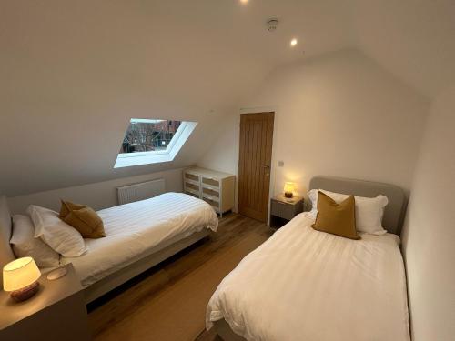 a bedroom with two beds and a window at Westwinds View in Ludlow