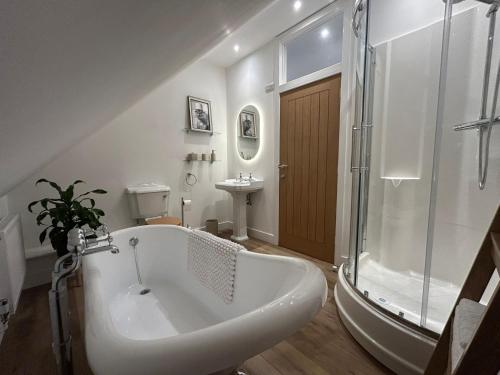 a bathroom with a tub and a shower and a sink at Westwinds View in Ludlow