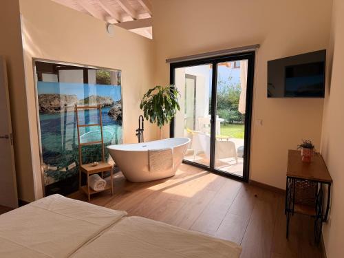 a large bathroom with a tub and a bedroom at Las Mareas de Llanes in Andrín