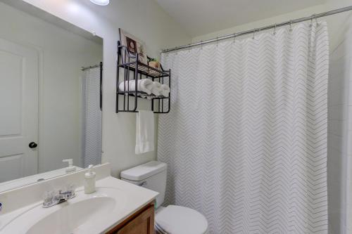 a bathroom with a sink and a shower curtain at Gated Cottage Community! Ideal Midtown Spot in Memphis