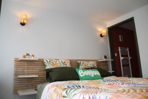 a bedroom with a bed with a wooden headboard at chez laetitia proche du puy in La Flocellière