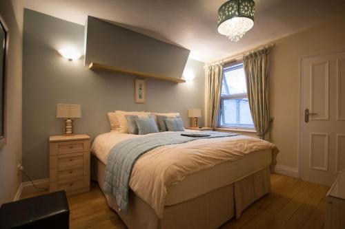 a bedroom with a large bed and a window at Atlantic Heights Guest House in St Ives
