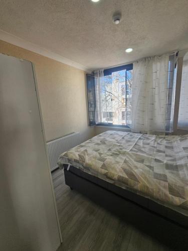 a bedroom with a bed and a large window at Royal Konaklama Manzara in Bandırma