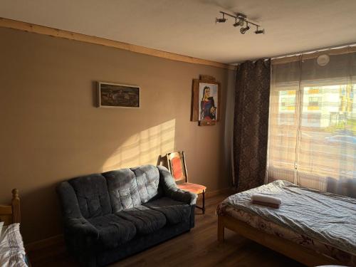 a living room with a couch and a window at 1-bedroom 2 big beds MV64 in Tartu
