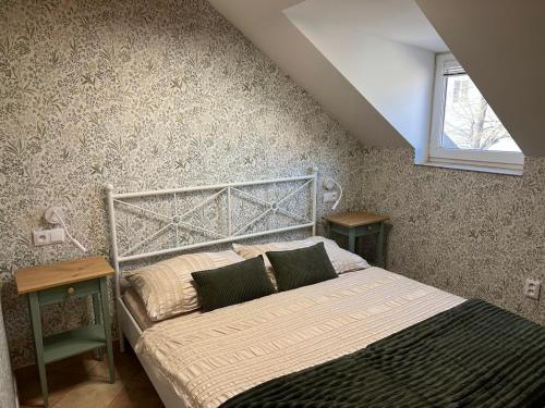 a bedroom with a bed and two night stands at Apartmán vinařství U Krčků in Zaječí