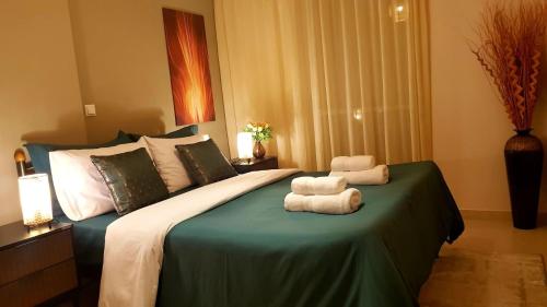 a bedroom with a bed with two towels on it at Ntarmos Apartment in Sparta