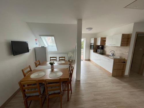 a kitchen and dining room with a table and chairs at Aurum Vendégház in Esztergom