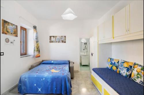 a small bedroom with a bed and a couch at House Le Antiche Mura in Castel Volturno