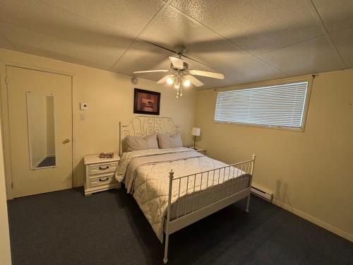 a bedroom with a bed and a ceiling fan at Finca Saddiki in Namur