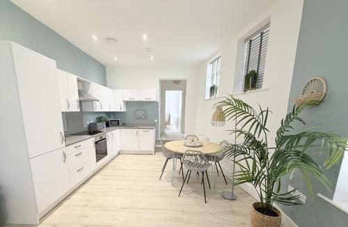 a kitchen with a table and a potted plant at Courtyard Retreat in Southampton