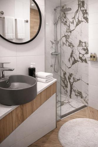 a bathroom with a sink and a shower at Hotelik Zielonka in Zielonka