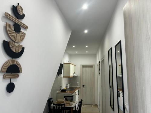 a hallway of a kitchen with a table and chairs at Happiness Apartment 7 in Sidari