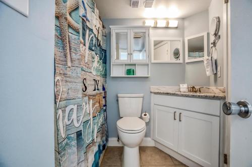 a bathroom with a toilet and a shower curtain at Carolina Reef #705 in Myrtle Beach