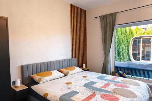 a bedroom with a bed with a large window at Kusagil Nature & Sauna near Pärnu in Tahkuranna