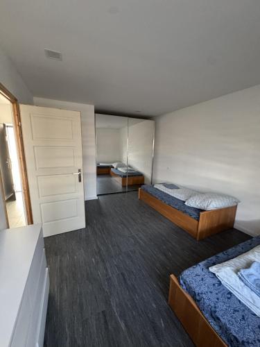 a small room with two beds and a closet at Beregi Apartman II in Mezőcsát