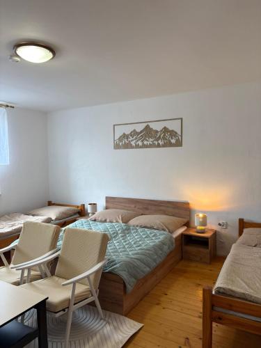 a bedroom with a bed and a table and chairs at Privat DAŇO in Lisková