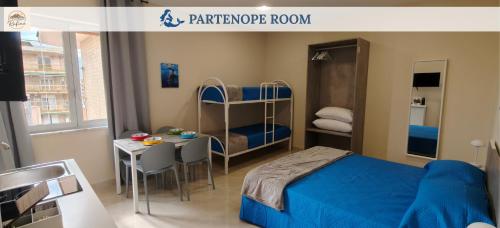 a bedroom with a bed and a table and a bunk bed at Rafinù B&B in Ercolano