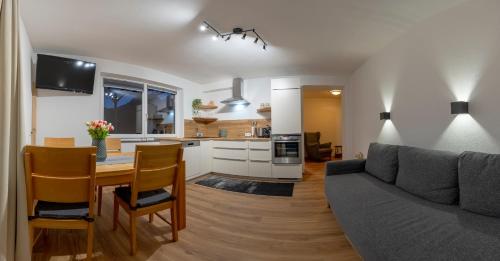 a living room and kitchen with a couch and a table at Ferienwohnung Bergsonne in Telfes im Stubai