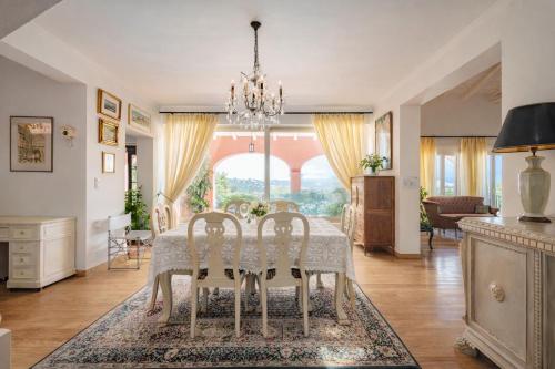 a dining room with a table and chairs at Villa Olea Corfu - Private Pool & Panoramic Views in Perama