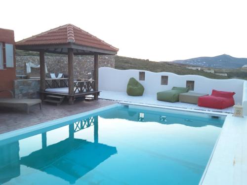 a villa with a swimming pool and a gazebo at Villa Zen Dans Le Bleu in Ermoupoli