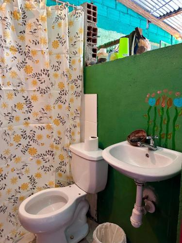 a bathroom with a toilet and a sink at El hada de Yumbilla in Cuispes