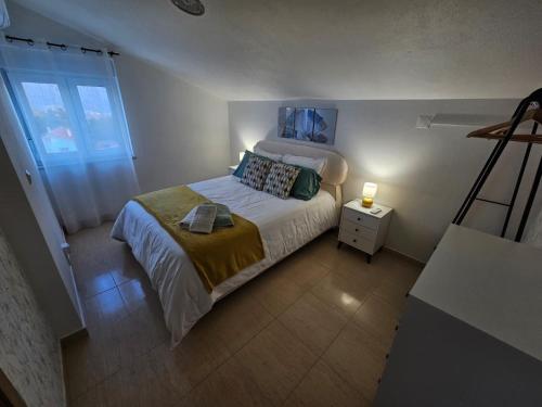 a small bedroom with a bed and a night stand at Casa Serra à Vista AL/140571 in Pedreiras