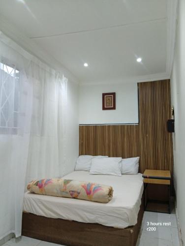 a bedroom with a large bed with a window at 3 bedroom self catering in Rustenburg